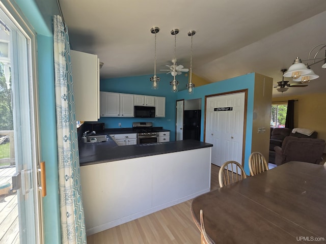 49962 Rosenlund Rd, Hancock, MI 49930 - kitchen with black microwave, stainless steel range with gas stovetop, dark countertops, light wood finished floors, and a peninsula