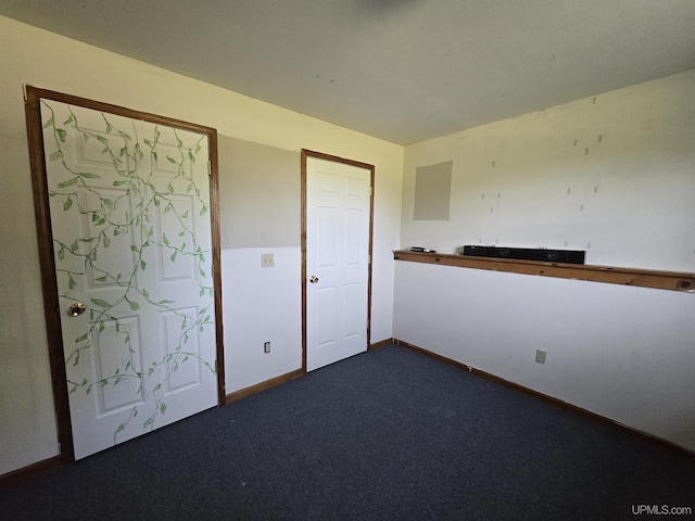 49962 Rosenlund Rd, Hancock, MI 49930 - unfurnished room featuring dark colored carpet and baseboards