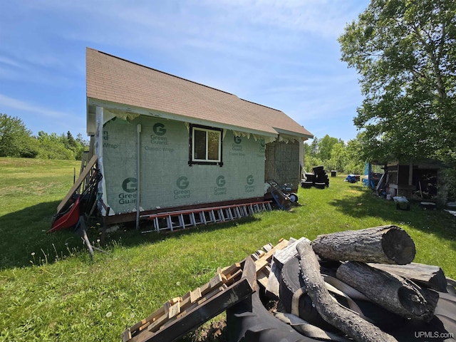 49962 Rosenlund Rd, Hancock, MI 49930 - back of house with a yard, concrete block siding, and roof with shingles