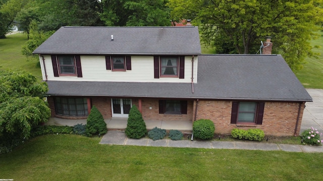 71800 Coon Creek Rd, Armada, MI 48005 - view of front facade featuring a chimney, brick siding, a front lawn, and roof with shingles