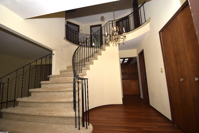 71800 Coon Creek Rd, Armada, MI 48005 - stairs featuring wood finished floors, a chandelier, and a towering ceiling