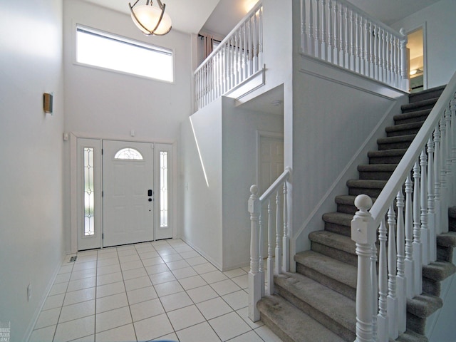 20343 Nicol Creek Dr, Macomb Twp, MI 48044 - entryway with a towering ceiling, stairs, and light tile patterned floors