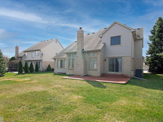 20343 Nicol Creek Dr, Macomb Twp, MI 48044 - back of house with brick siding, a yard, and a chimney