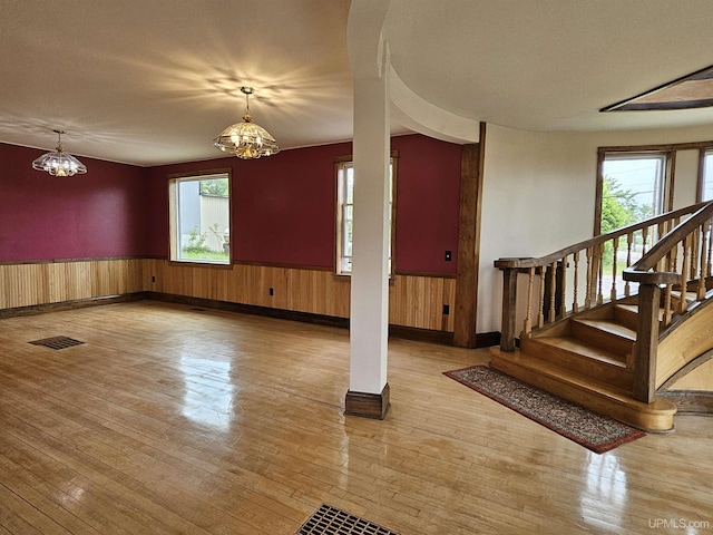 52377 Duncan Ave, Hubbell, MI 49934 - foyer entrance featuring wainscoting, wood-type flooring, a chandelier, healthy amount of natural light, and stairway