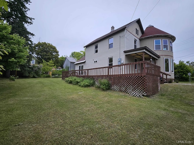 52377 Duncan Ave, Hubbell, MI 49934 - rear view of property featuring a deck, a lawn, a chimney, and board and batten siding