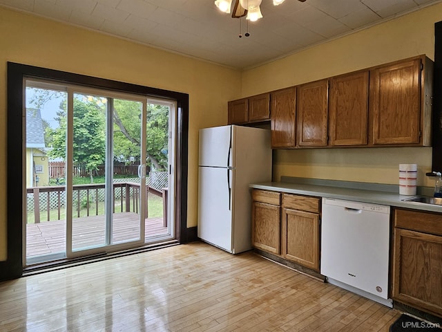 52377 Duncan Ave, Hubbell, MI 49934 - kitchen with white appliances, light wood-style flooring, ceiling fan, and brown cabinetry