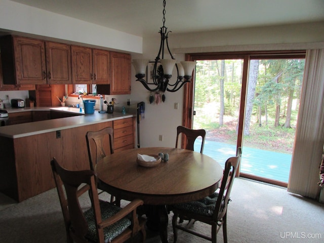 20517 Park Rd, Skanee, MI 49962 - dining area featuring light colored carpet and a chandelier