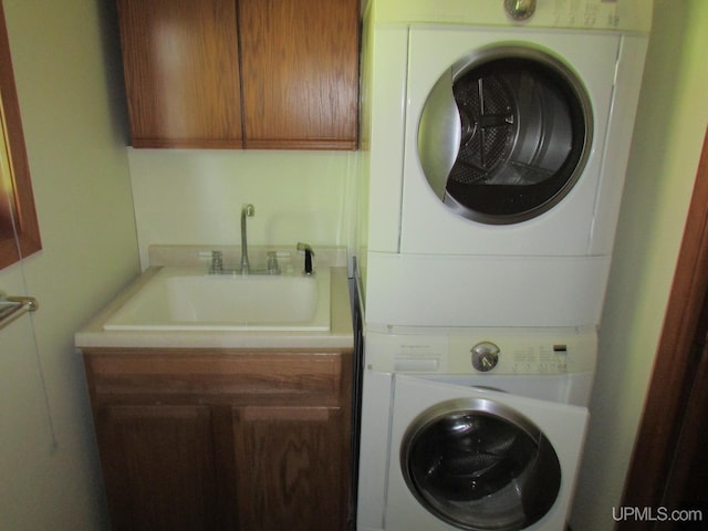20517 Park Rd, Skanee, MI 49962 - laundry room featuring stacked washer / dryer and cabinet space