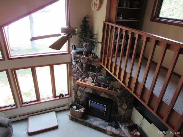 20517 Park Rd, Skanee, MI 49962 - living area with a baseboard heating unit and a fireplace
