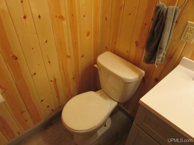 20517 Park Rd, Skanee, MI 49962 - half bathroom featuring vanity, wood finished floors, and wooden walls