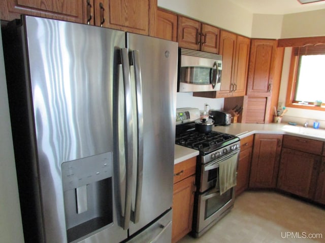 20517 Park Rd, Skanee, MI 49962 - kitchen featuring appliances with stainless steel finishes, brown cabinets, and light countertops