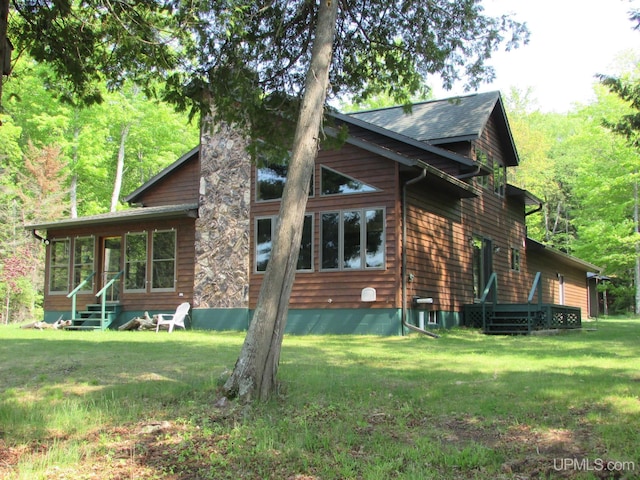 20517 Park Rd, Skanee, MI 49962 - rear view of property with a yard, entry steps, and a sunroom