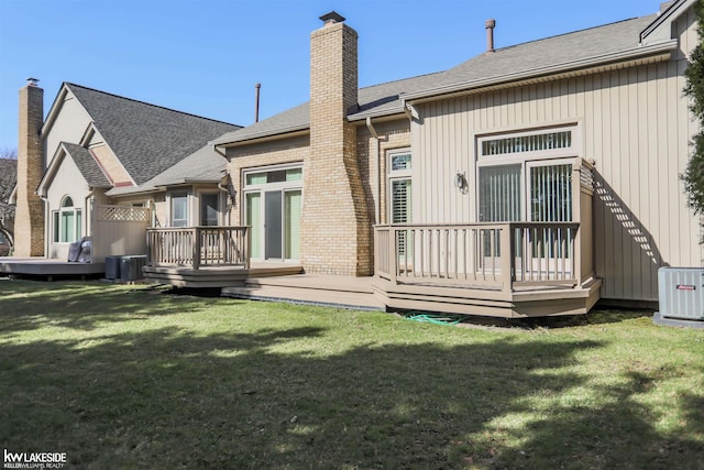 54826 Cambridge Dr, Shelby, MI 48315 - rear view of property with a chimney, a deck, a yard, and roof with shingles