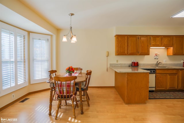 54826 Cambridge Dr, Shelby, MI 48315 - kitchen featuring white dishwasher, healthy amount of natural light, brown cabinets, and a peninsula