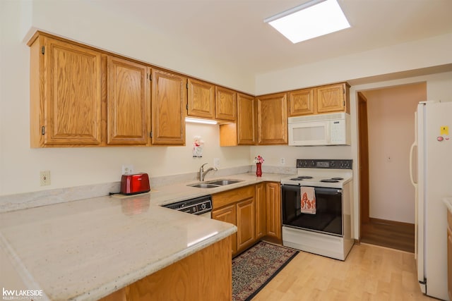 54826 Cambridge Dr, Shelby, MI 48315 - kitchen with white appliances, light countertops, a peninsula, light wood-style flooring, and brown cabinets