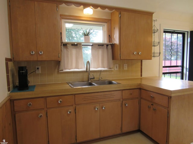 32900 Knapp Ave, Warren, MI 48093 - kitchen featuring a peninsula, light countertops, and decorative backsplash