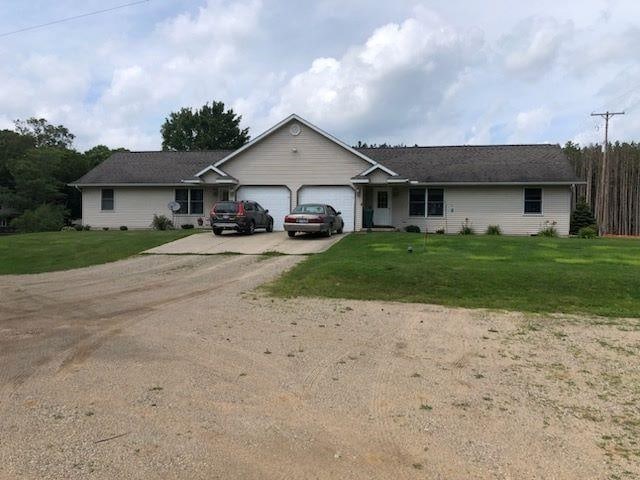 10195 S Lake Station Ave, Lake, MI 48632 - ranch-style home featuring concrete driveway, an attached garage, and a front yard
