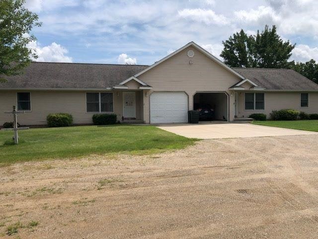 10195 S Lake Station Ave, Lake, MI 48632 - single story home with a garage, concrete driveway, and a front lawn