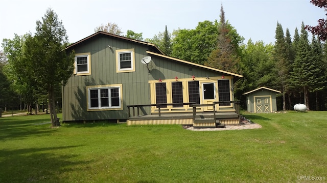 10031 N Ross Lake Rd, Shingleton, MI 49884 - rear view of property with a storage unit, a deck, and a lawn
