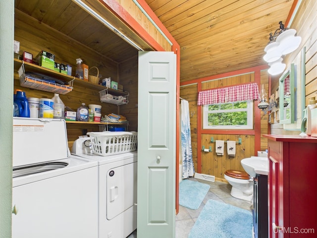 10031 N Ross Lake Rd, Shingleton, MI 49884 - laundry room with wood walls, wooden ceiling, independent washer and dryer, and light tile patterned floors