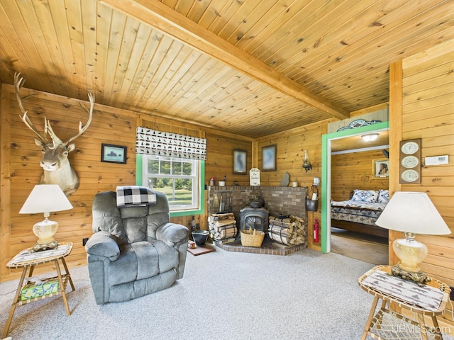 10031 N Ross Lake Rd, Shingleton, MI 49884 - carpeted living room featuring wooden walls, a wood stove, and a wood ceiling with exposed beams