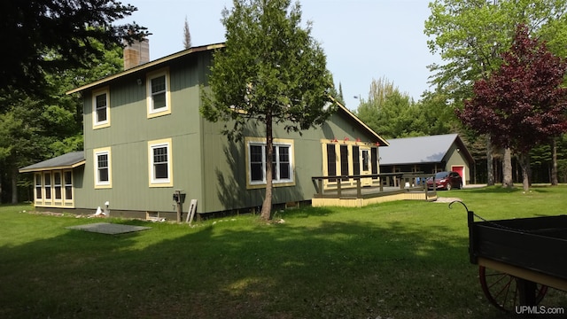 10031 N Ross Lake Rd, Shingleton, MI 49884 - rear view of property featuring a lawn, a chimney, and a wooden deck