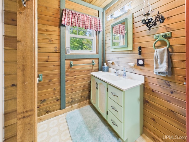 10031 N Ross Lake Rd, Shingleton, MI 49884 - bathroom featuring wooden walls, vanity, and tile patterned floors