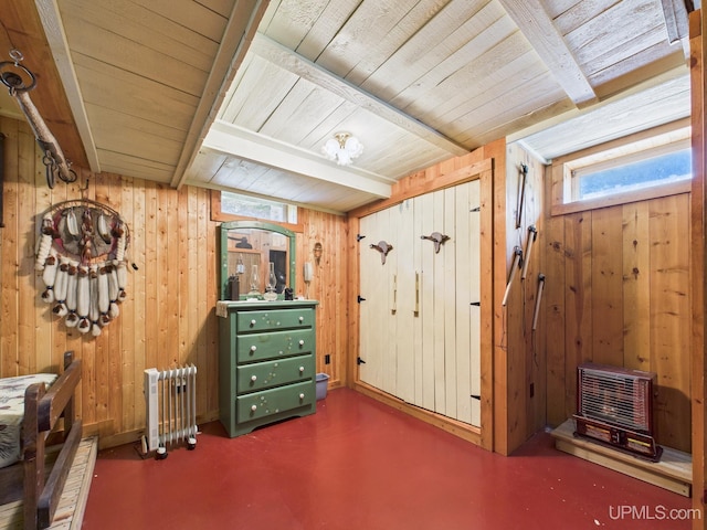 10031 N Ross Lake Rd, Shingleton, MI 49884 - bedroom with a wood ceiling with exposed beams, multiple windows, wood walls, finished concrete flooring, and radiator