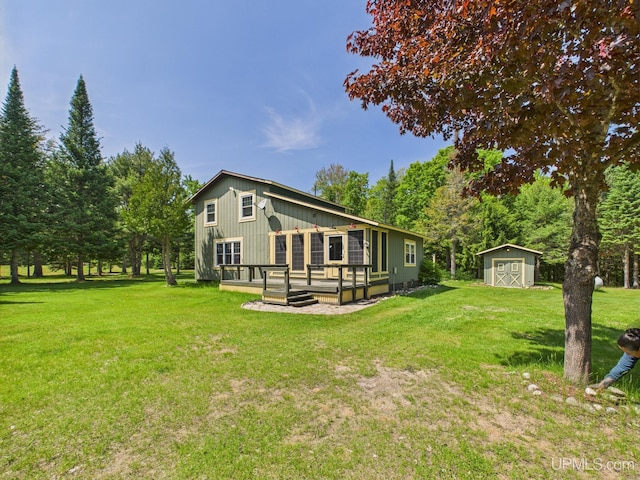 10031 N Ross Lake Rd, Shingleton, MI 49884 - rear view of property with a storage shed, a wooden deck, and a yard