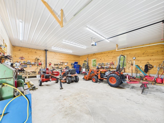 10031 N Ross Lake Rd, Shingleton, MI 49884 - garage with a workshop area, wood walls, and a garage door opener
