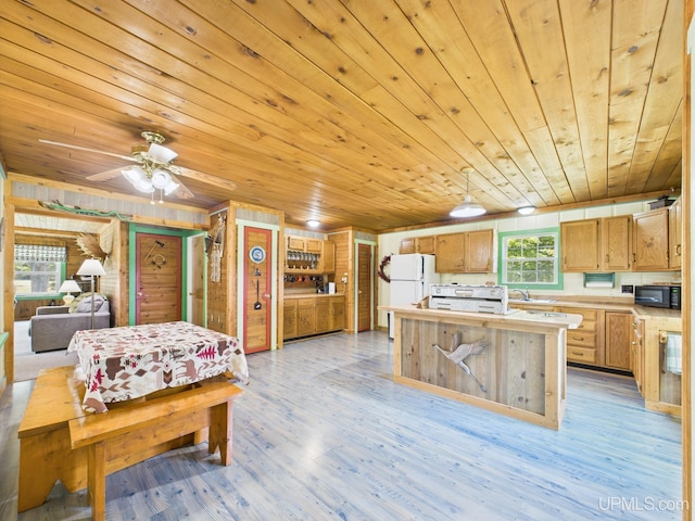 10031 N Ross Lake Rd, Shingleton, MI 49884 - kitchen featuring freestanding refrigerator, black microwave, wooden ceiling, a kitchen island, and light countertops