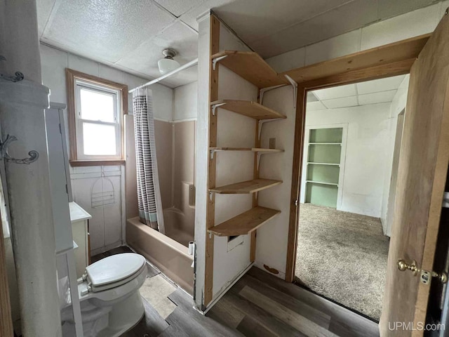 228 Schoolcraft Ave, Manistique, MI 49854 - full bath featuring wood finished floors, shower / tub combo, and vanity