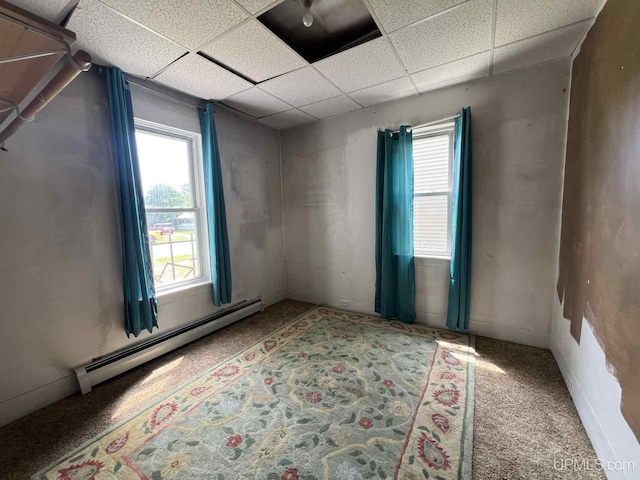228 Schoolcraft Ave, Manistique, MI 49854 - spare room with a baseboard radiator, carpet flooring, and a drop ceiling