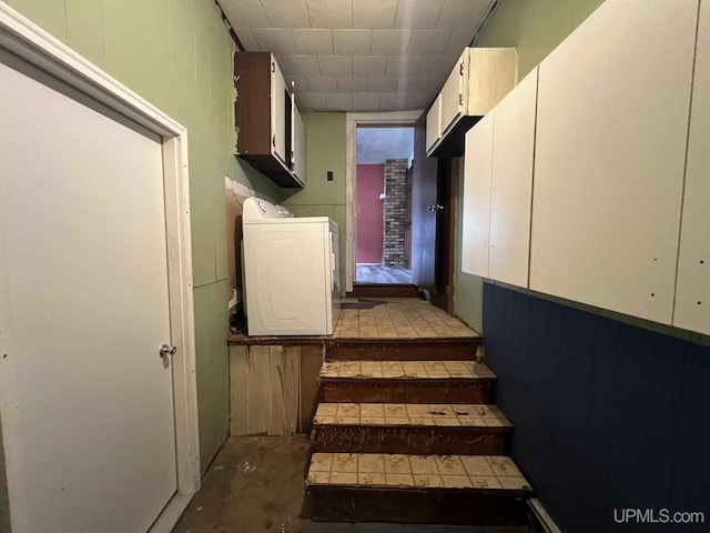 228 Schoolcraft Ave, Manistique, MI 49854 - stairs with washer / dryer and unfinished concrete flooring