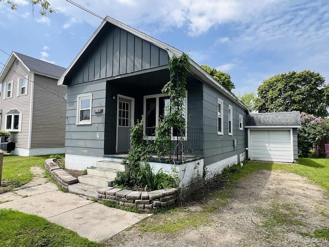 228 Schoolcraft Ave, Manistique, MI 49854 - bungalow-style house with board and batten siding and dirt driveway