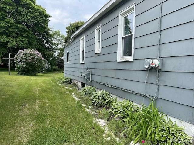 228 Schoolcraft Ave, Manistique, MI 49854 - view of side of home featuring a yard