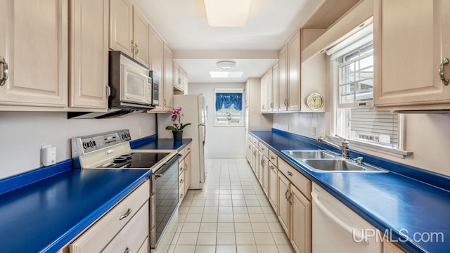 216 Mine St, Norway, MI 49870 - kitchen with white appliances, plenty of natural light, light tile patterned floors, and dark countertops