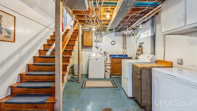 216 Mine St, Norway, MI 49870 - basement featuring separate washer and dryer, refrigerator, and stairs