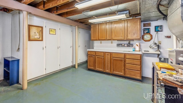 216 Mine St, Norway, MI 49870 - kitchen with concrete flooring, light countertops, and brown cabinetry
