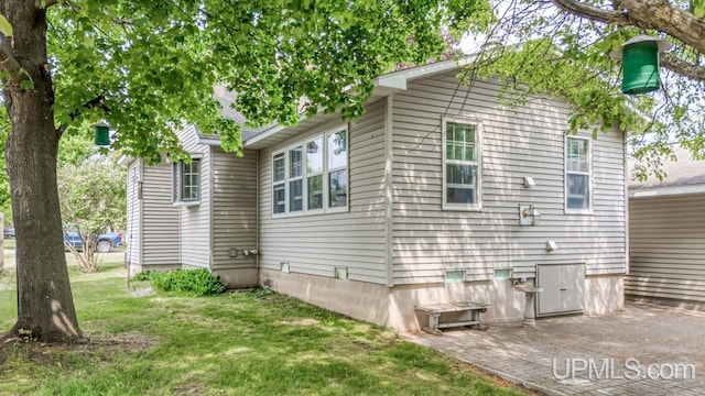 216 Mine St, Norway, MI 49870 - view of side of home featuring a yard and a patio