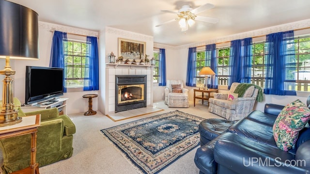 216 Mine St, Norway, MI 49870 - carpeted living room featuring a tile fireplace and ceiling fan