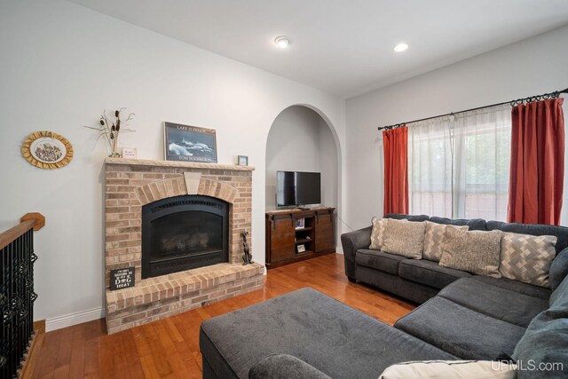 821 Camelot Dr, Negaunee, MI 49866 - living area with wood finished floors, a fireplace, and recessed lighting