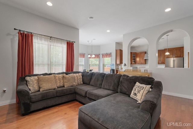 821 Camelot Dr, Negaunee, MI 49866 - living area featuring light wood finished floors, recessed lighting, and arched walkways