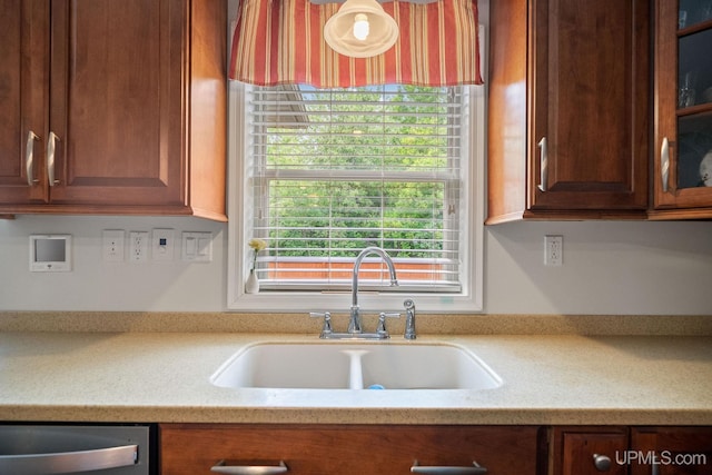 821 Camelot Dr, Negaunee, MI 49866 - kitchen featuring dishwasher, glass insert cabinets, and light stone countertops