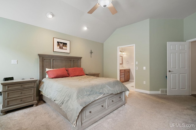821 Camelot Dr, Negaunee, MI 49866 - bedroom with lofted ceiling, light carpet, connected bathroom, and a ceiling fan