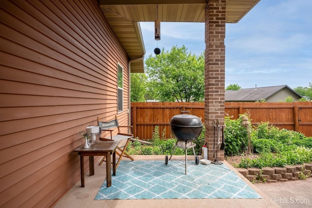 821 Camelot Dr, Negaunee, MI 49866 - fenced backyard featuring a patio area and a grill