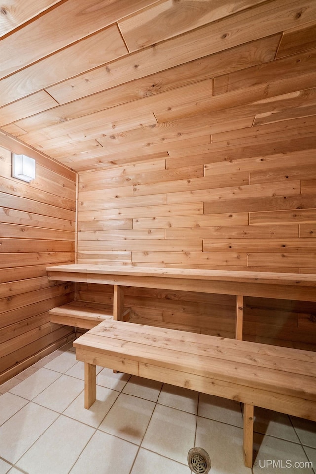 821 Camelot Dr, Negaunee, MI 49866 - relaxing sauna / steam room with tile patterned flooring, wood walls, and wooden ceiling