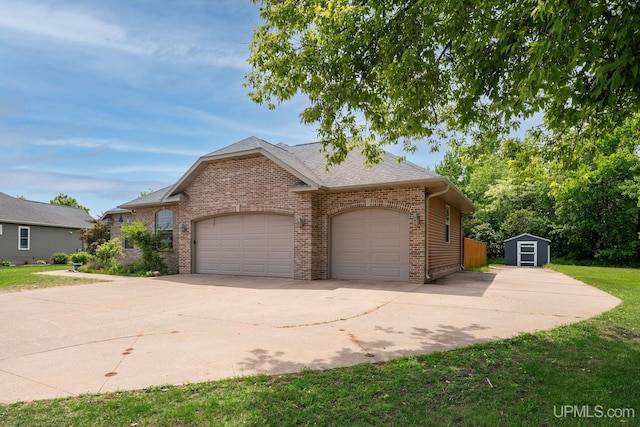 821 Camelot Dr, Negaunee, MI 49866 - view of front of house featuring brick siding, a garage, a storage shed, concrete driveway, and a front lawn