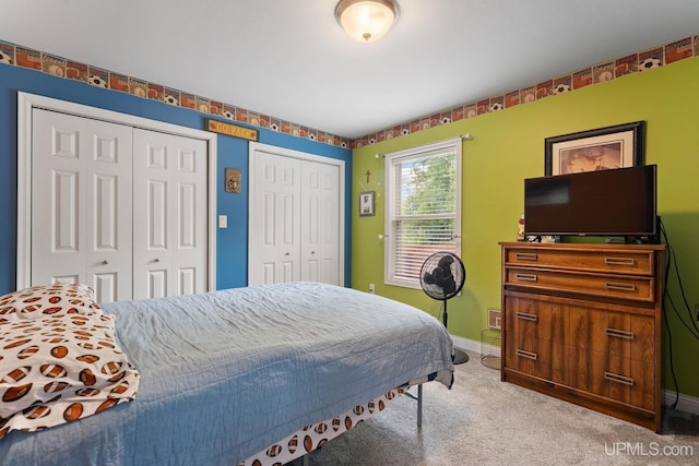 821 Camelot Dr, Negaunee, MI 49866 - carpeted bedroom featuring multiple closets and baseboards