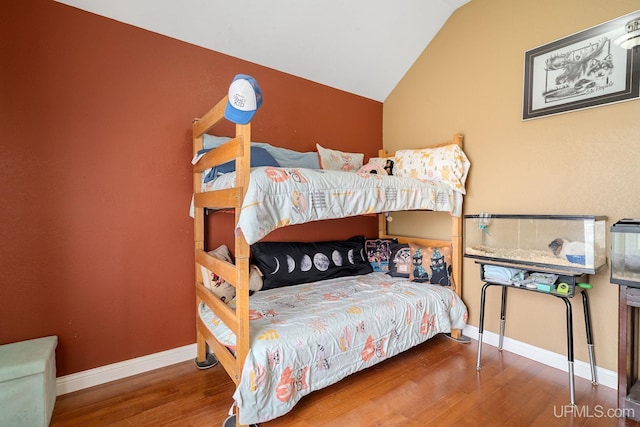821 Camelot Dr, Negaunee, MI 49866 - bedroom featuring wood finished floors and lofted ceiling